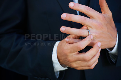 Buy stock photo Man, groom and hands with ring for marriage, commitment or symbol of love, trust or care. Closeup of married male person in suit adjusting jewelry on finger for vow, promise or wedding engagement