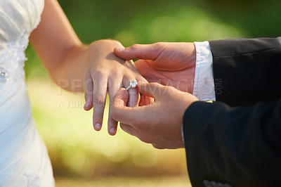 Buy stock photo Closeup, wedding and hands with a ring, love ceremony and commitment with partnership, religious ritual and marriage. Zoom, couple or bride with groom, jewellery or relationship with romance or trust