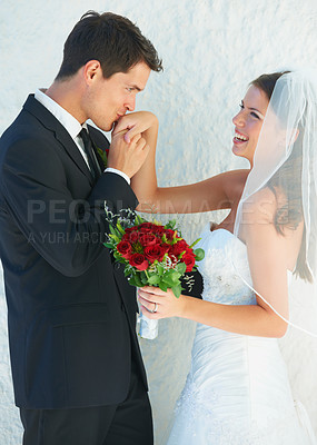 Buy stock photo Romance, happy couple and kiss on hand at wedding with smile, bouquet and commitment at reception. Flowers, woman and man in embrace at marriage celebration with roses, loyalty and future together.