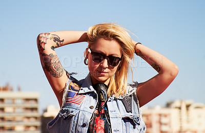 Buy stock photo Shot of a young woman with tattoos