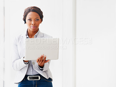 Buy stock photo A young african american woman working on her laptop alongside copyspace