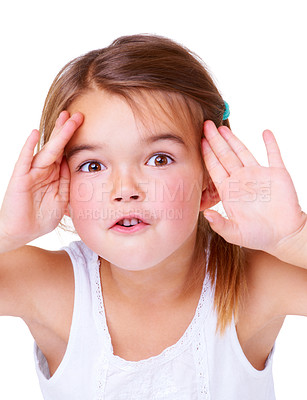 Buy stock photo Portrait, surprise and peekaboo with a girl child in studio isolated on a white background for a playful game. Face, hands or wow and a cute young kid having fun with a gesture for comedy or humor