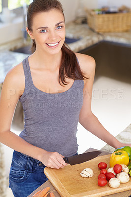 Buy stock photo Woman, portrait and happy with knife or vegetables for nutrition, cooking or healthy meal in kitchen of home. Person, face and chopping board with mushroom, peppers and tomato for wellness and diet