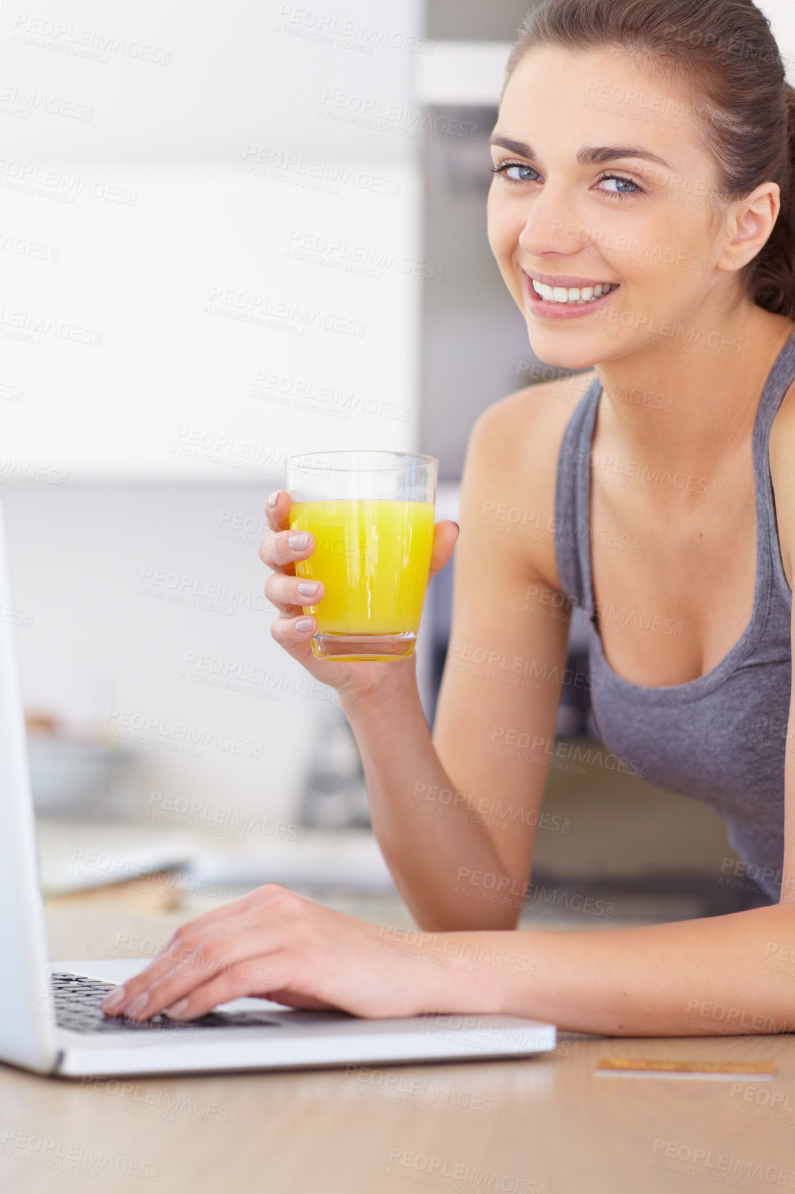 Buy stock photo Portrait, laptop and smile for orange juice with a woman in the kitchen of her home to relax in the morning. Computer, online shopping and a happy young person in the apartment for ecommerce payment