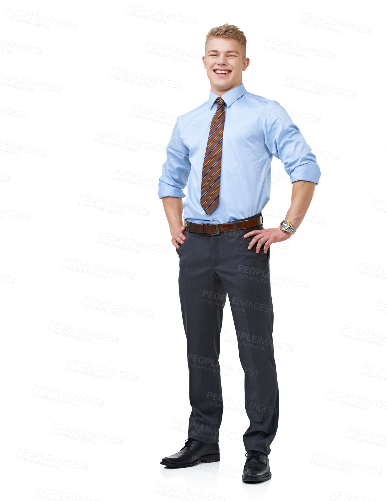 Buy stock photo A young businessman in a shirt and tie with his hands on his hips