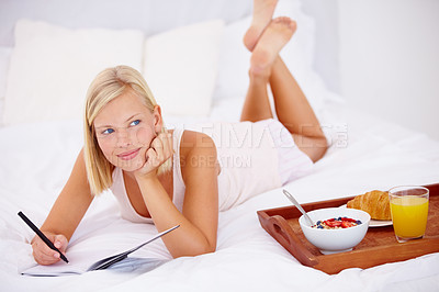 Buy stock photo Woman, bed and notebook with breakfast, happy and writing in diary, thinking and bedroom for journaling. Food, fruits and croissant with orange juice, nutrition or healthy diet in home, rest or relax
