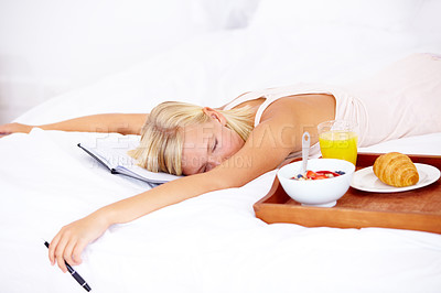 Buy stock photo Woman, bed and notebook with breakfast, sleep and tired with diary, bedroom and journaling. Food, fruits and croissant with orange juice, nutrition and healthy diet in home, rest and morning
