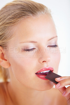 Buy stock photo Relax woman, face and eating chocolate, delicious snack or candy for studio food, dessert or sugar calorie. Eyes closed, cacao sweets and model enjoy wellness cheat meal isolated on white background