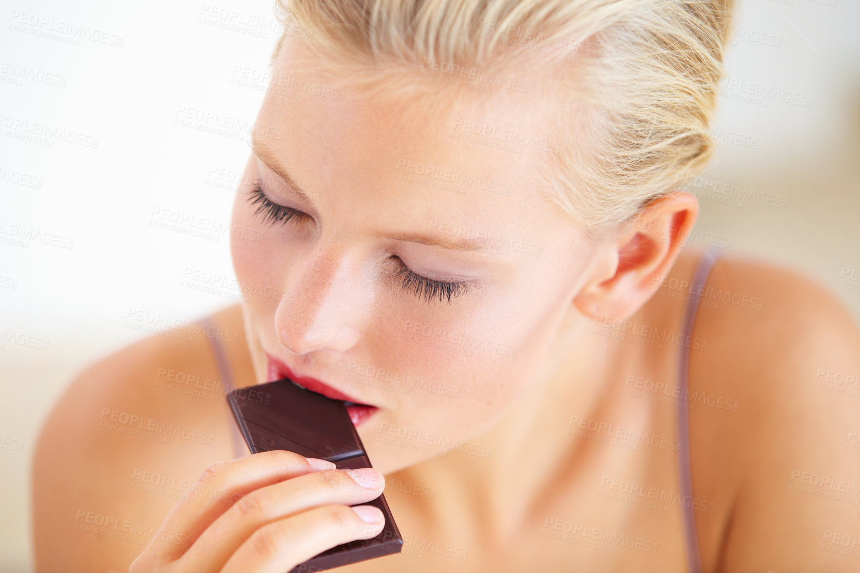Buy stock photo Relax woman, face and eating dark chocolate for antioxidants benefits, morning wellness or stress relief food. Diet cheat meal, eyes closed and person enjoy sugar craving, cacao bar or sweets slab
