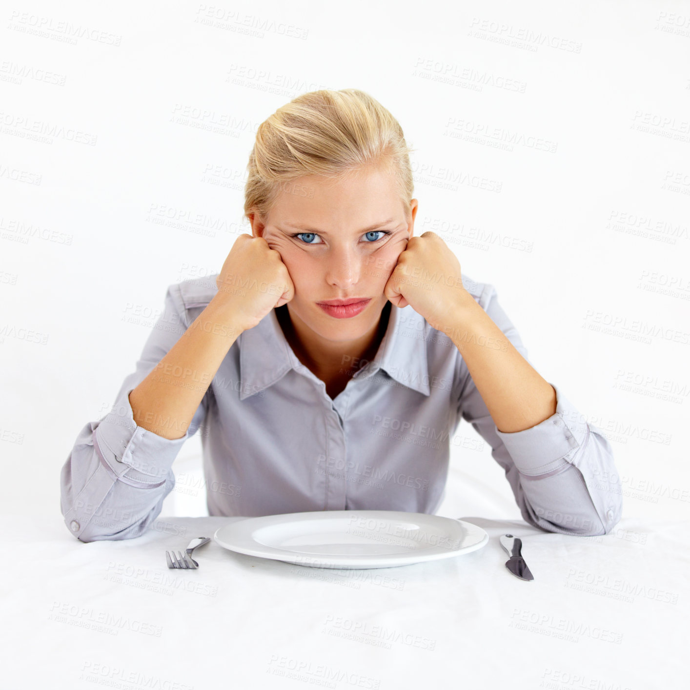 Buy stock photo Bored, portrait and woman with a plate in a studio with upset, frustrated and grumpy face. Angry, hungry and young female person from Australia with dish and cutlery isolated by white background.