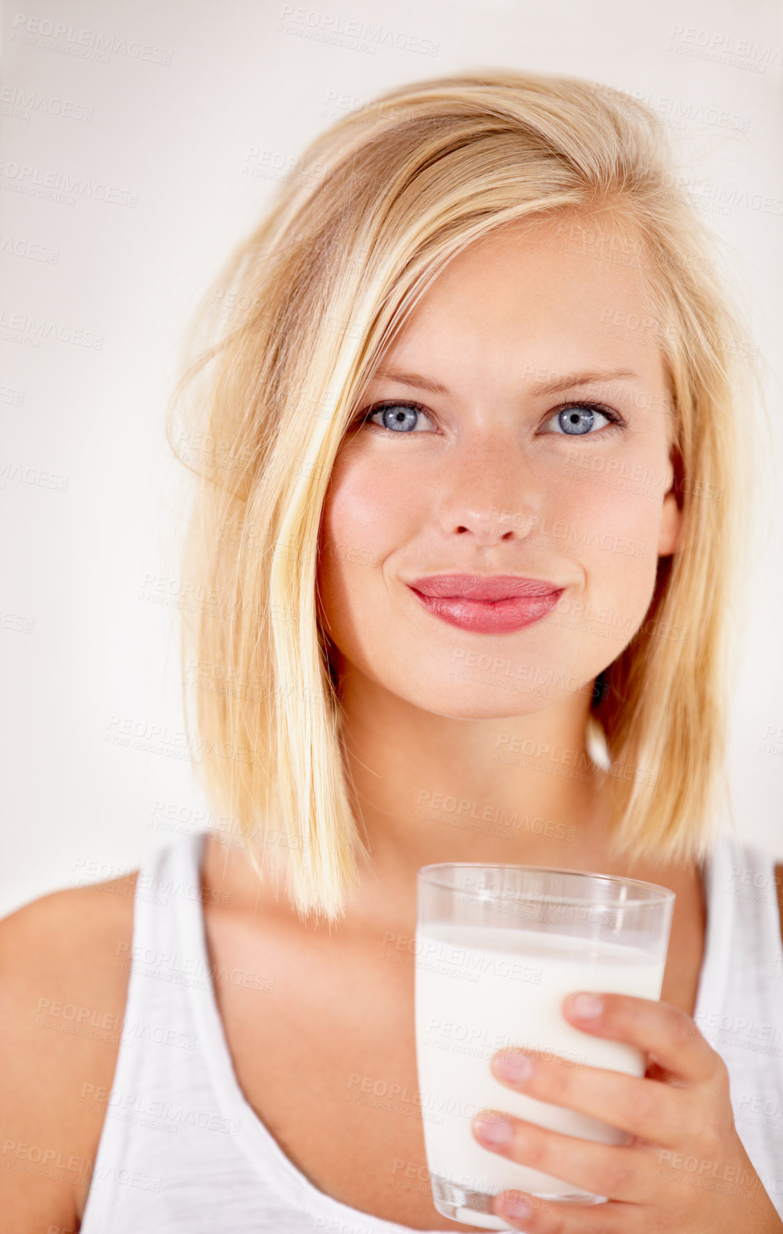 Buy stock photo Shot of a young woman enjoying a drink