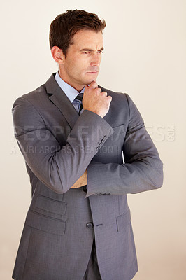 Buy stock photo A handsome young businessman looking thoughtful