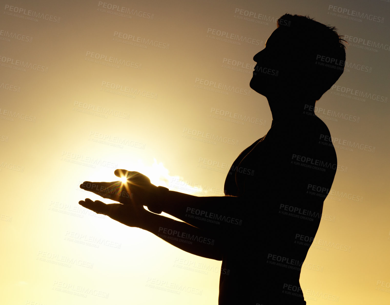 Buy stock photo A silhouette of a man standing calmly with his hands raised 
