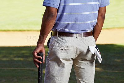 Buy stock photo Rearview cropped shot of a golfer midsection with a glove hanging out of his back pocket