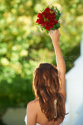 Buy stock photo Woman, back and wedding rose bouquet with love, commitment and trust ceremony for marriage. Engagement, celebration and flowers for event in a park with a red floral plant and bride dress outdoor