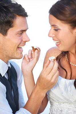 Buy stock photo Wedding, cake and couple with smile, feeding and commitment celebration at luxury event together. Sharing dessert, eating and woman with man at marriage party with tradition, loyalty culture and love