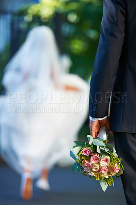 Buy stock photo Cropped shot of a disheartened groom as his bride runs away in the distance