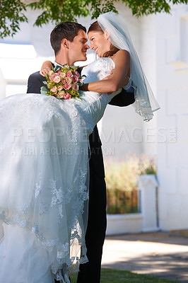 Buy stock photo Man carrying woman in garden at wedding with love, commitment and luxury outdoor event. Romantic marriage, embrace and smile, happy couple outside church in celebration with a bride and groom.