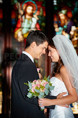 Buy stock photo Happy couple, wedding and love at church for marriage, affection or commitment together at ceremony. Married man and woman touching foreheads with bouquet of roses or flowers in romantic relationship