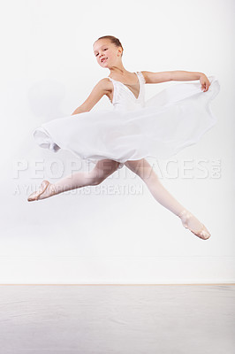 Buy stock photo Shot of a young ballerina leaping across the floor of a dance studio