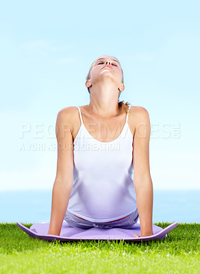 Buy stock photo An attractive young woman doing yoga outdoors