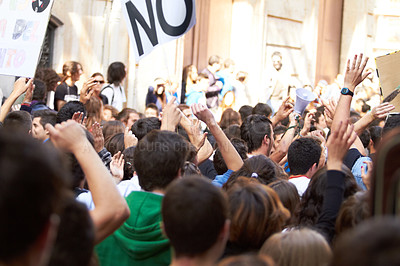 Buy stock photo Rearview shot of a crowd protesting outside a public building