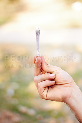 Buy stock photo Marijuana, cannabis or hand with weed joint for a calm peace to relax or help reduce pain, stress or anxiety. Trippy, smoking or closeup of person showing a blunt for mental health benefits outdoors