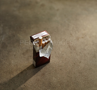 Buy stock photo Closeup shot of an open box of cigarettes, with one sticking up out of the box