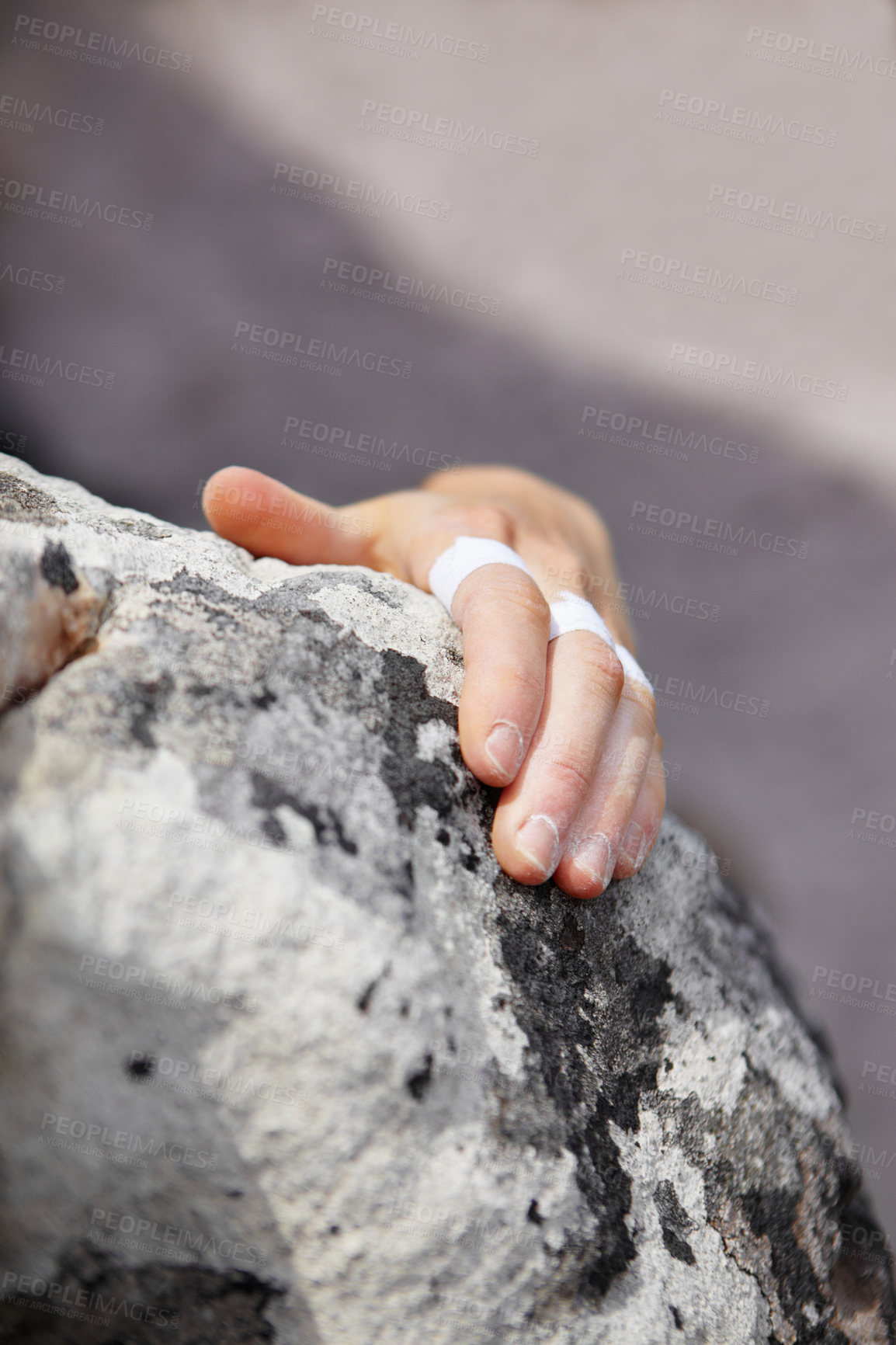 Buy stock photo Person, grip and rock climbing or finger tape on hand for exercise injury, sports pain on nature cliff. Athlete, boulder and hanging for explore peak practice for brave adventure, risk on mountain