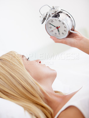 Buy stock photo Woman, holding and alarm clock for wake up in bedroom for early, morning and sleep in house. Female person, looking and time with upset, serious and expression for day with noise, alert and sound