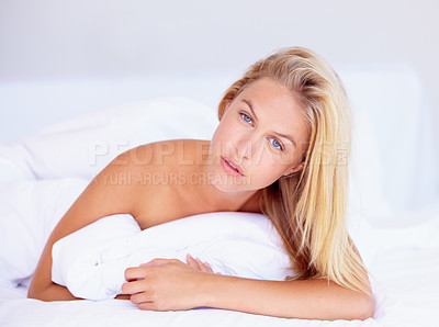 Buy stock photo Woman, face and looking with portrait for lying on bed for relaxing, rest or peace in home. Female person, think and pose in serious expression for wake up, pillow and alone with cool, trendy or hair