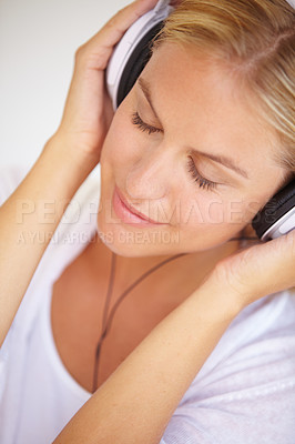 Buy stock photo Woman, eyes closed and smile with headphones in closeup for music, podcast or radio. Person, calm or peaceful expression on face for listening, audio or song in home streaming service on internet