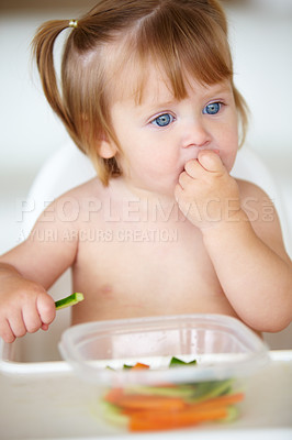 Buy stock photo A cute little girl eating vegetables