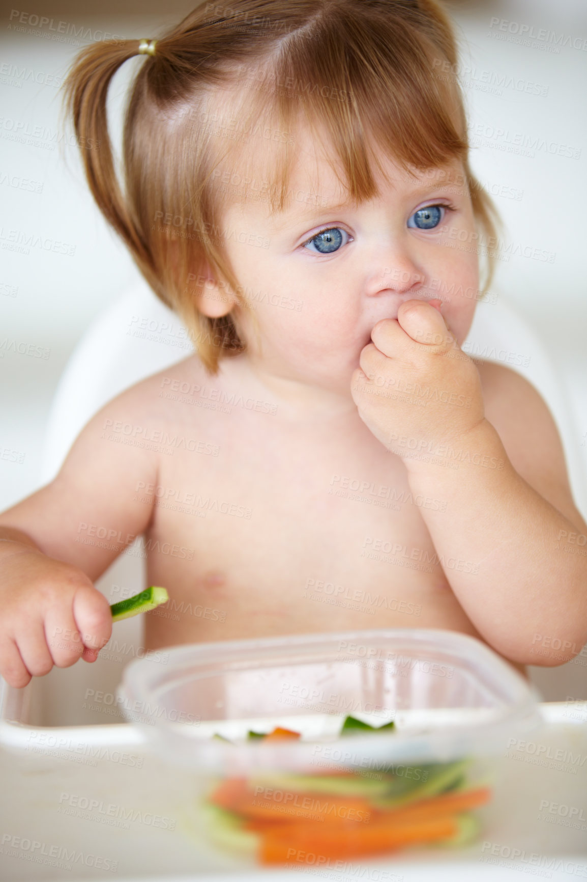 Buy stock photo A cute little girl eating vegetables