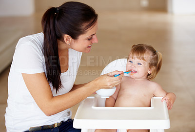 Buy stock photo Family, food and a mother feeding her baby breakfast in the morning while in a home together for development. Children, growth and a girl toddler eating with her woman parent in an apartment kitchen