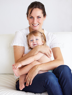 Buy stock photo A cute little girl being held by her mother