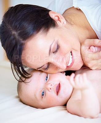 Buy stock photo Face, family or love with a mother and baby closeup on a bed in their home together for bonding. Growth, smile or happy with a young woman parent and infant child in the bedroom of an apartment
