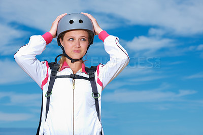 Buy stock photo Woman, skydiver and helmet in outdoors, adventure and recreation or extreme sports for fun or equipment. Female person, travel and outside or fitness, holiday and vacation or getaway by blue sky