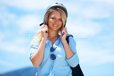 Buy stock photo Beautiful woman putting on a skydiving helmet outdoors