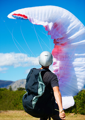 Buy stock photo Man, parachute and launch sport with courage, healthy adventure and paragliding for extreme fitness. Person, preparation and fearless in forest for flight take off with helmet and safety gear in wind