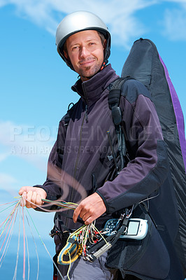 Buy stock photo Paragliding, parachute and man with portrait in nature in preparation, exercise or health support. Athlete, face or fitness for happy outdoor with safety harness, helmet or equipment in countryside