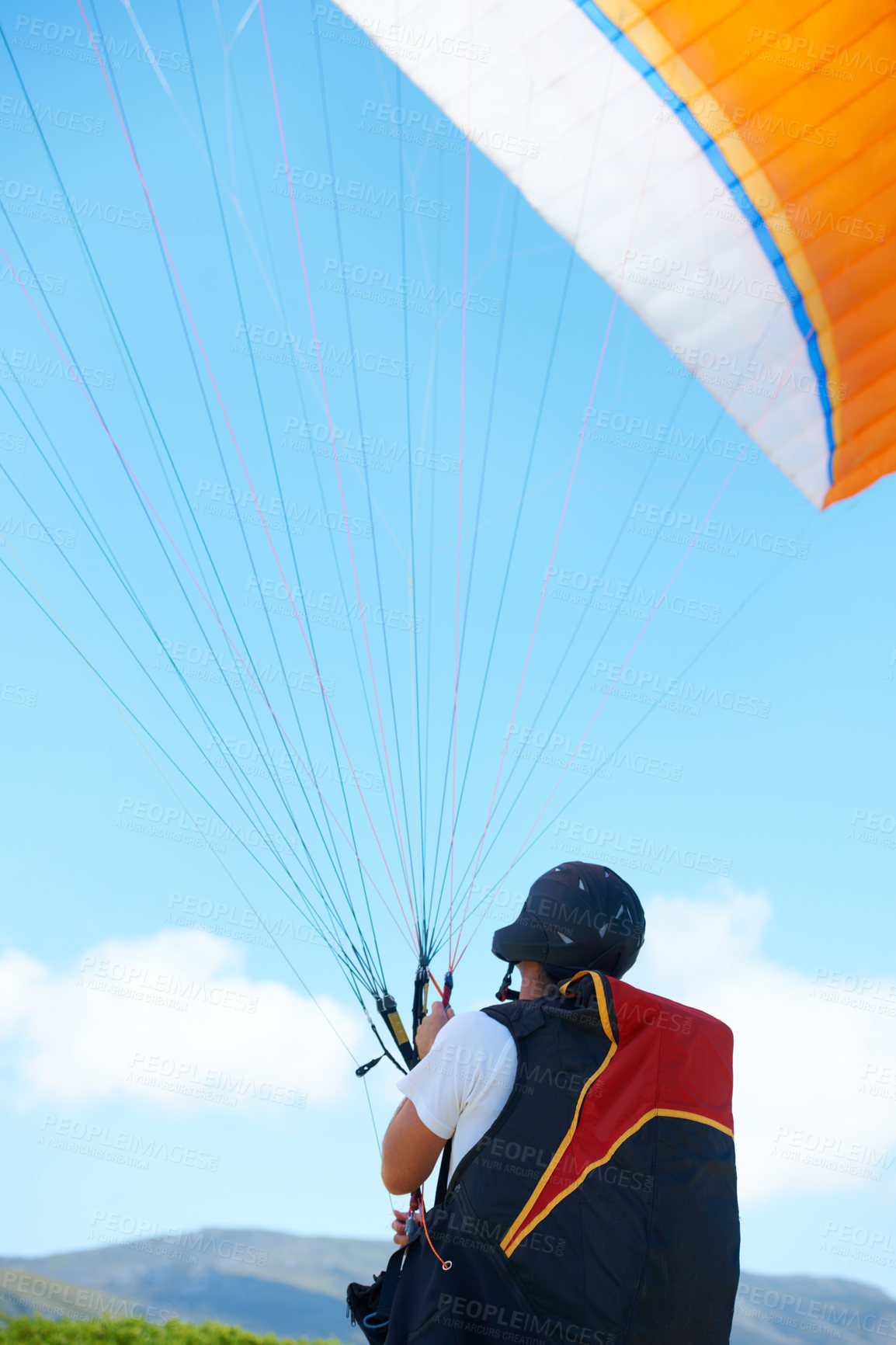 Buy stock photo Nature, sport or man with parachute in preparation, launch or paragliding training for adventure in extreme exercise. Person, balance or strings for outdoor fun or fitness with helmet or safety gear