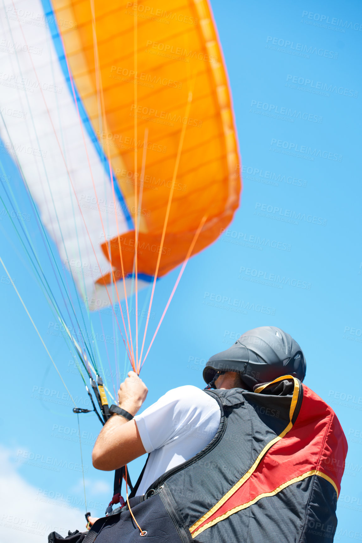 Buy stock photo Shot of a man paragliding on a sunny day