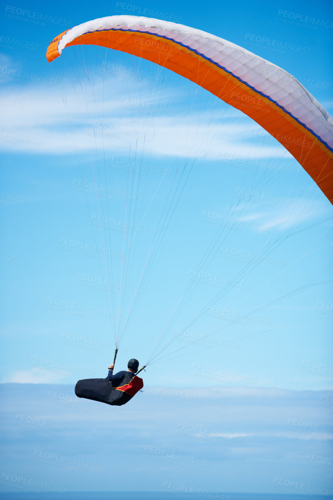 Buy stock photo Man, paragliding and blue sky adventure parachute in clouds for explore city, outdoor courage or fearless athlete. Male person, safety equipment for landing flying in nature sport, activity in wind