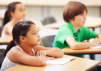 Buy stock photo Education, students and girl in classroom with focus, attention and study at Montessori school. Children at desk studying with notebook, child development and kid with concentration in lesson or test