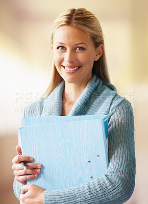 Buy stock photo A gorgeous young teacher standing in the hallway at school