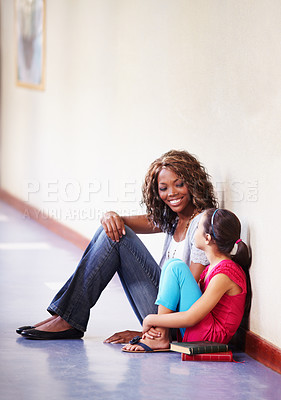 Buy stock photo Teacher, child and talking or conversation at school for support, trust or counselling. Happy black woman working at school for student discussion or education on bullying, learning and development