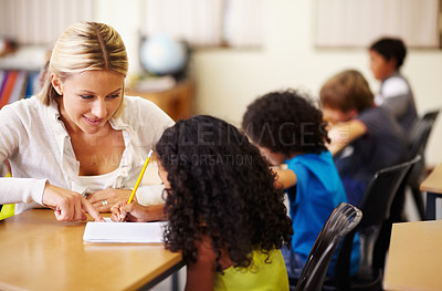 Buy stock photo School, education or learning with a teacher and student in a classroom during a lesson for child development. Study, kids or writing with a woman educator helping a girl pupil while sitting in class