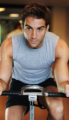 Buy stock photo Man, exercise bike and fitness at gym, endurance and training for competition, sweat and cardio. Male person, cycling and determination in workout, motivation and machine for wellness, club or class