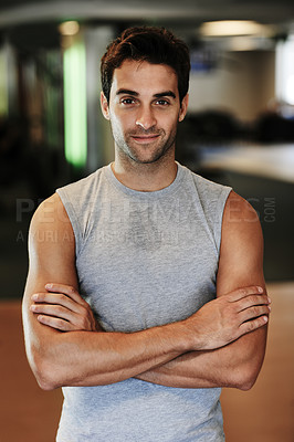 Buy stock photo Portrait of a man wearing sports clothing standing with arms crossed at the gym